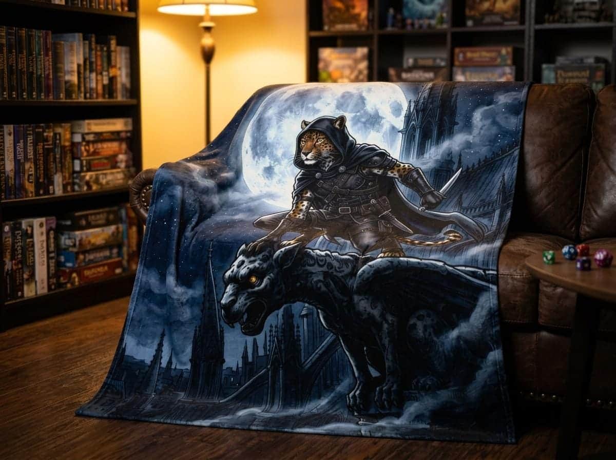 Photo 2 of 5: A plush velveteen throw blanket showcasing an agile feline rogue crouching across gothic cathedral spires under a giant silver moon, shown on a game room couch