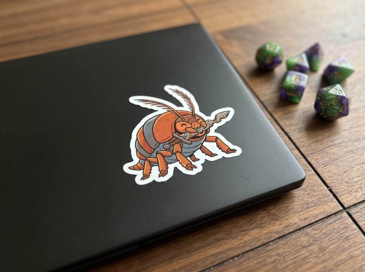 Photo 2 of 5: An inside-joke badge sticker depicting tabletop gaming's most feared blade-eating pest, shown on a laptop lid