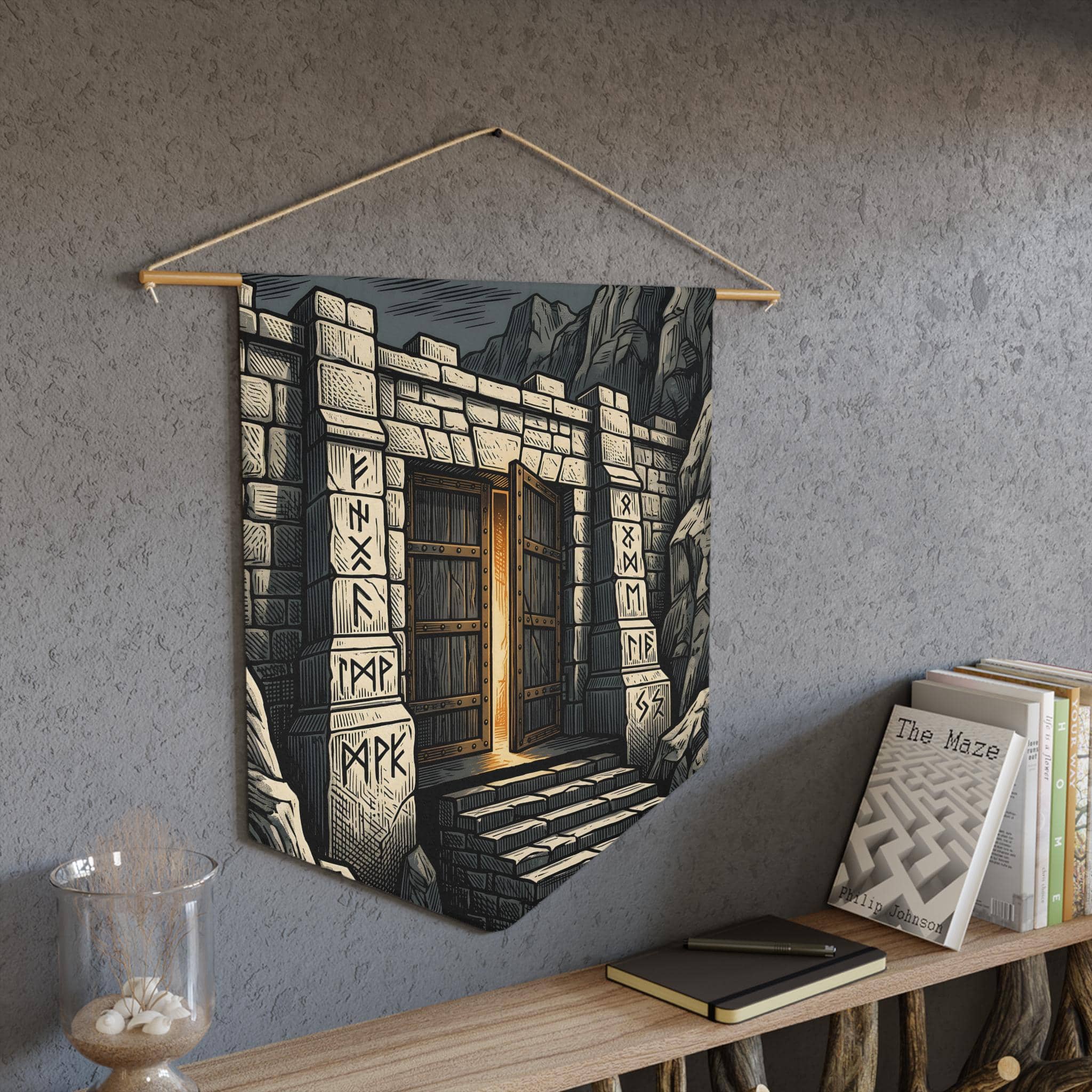A tapered heraldic wall banner featuring a monumental dwarven mountain fortress gate etched in gold and slate linocut, in a room setting