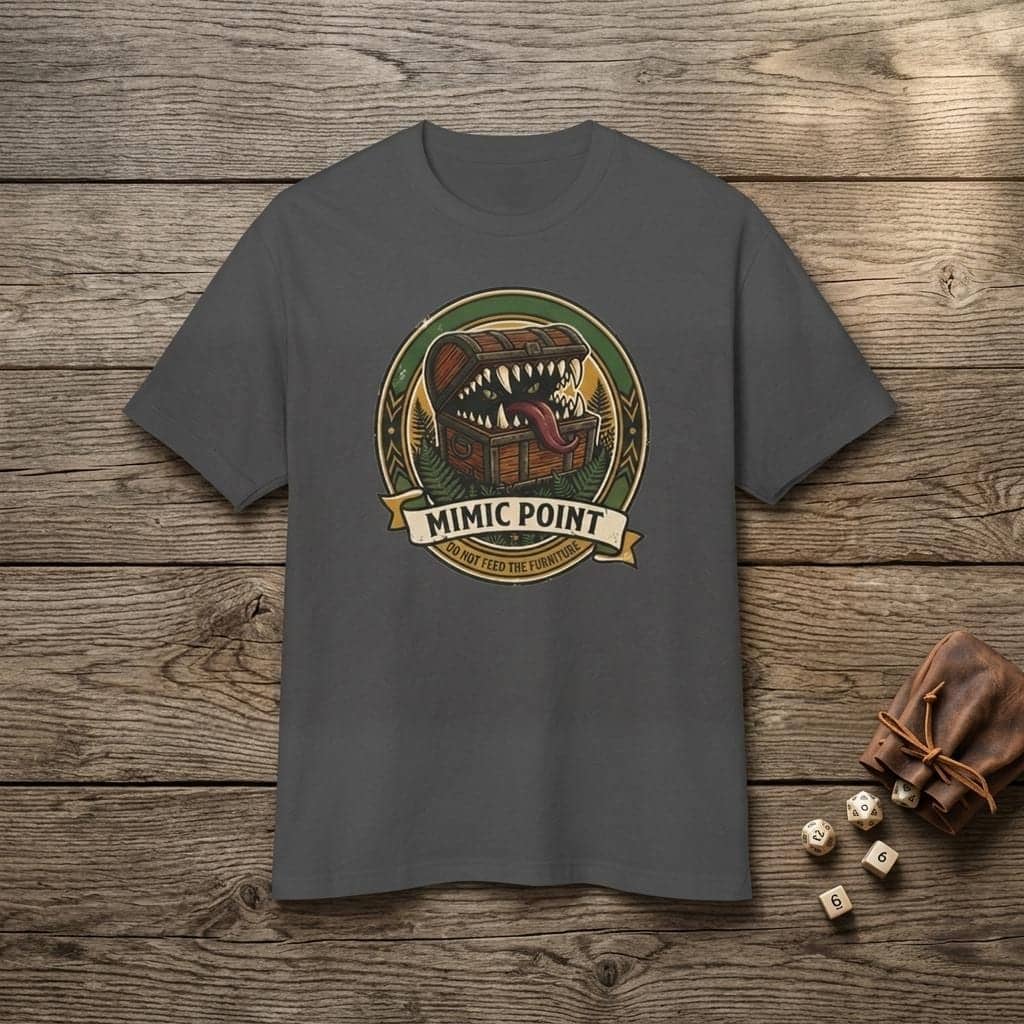 Deadpan national park badge tee warning dungeon adventurers against hungry furniture, shown laid flat among dice