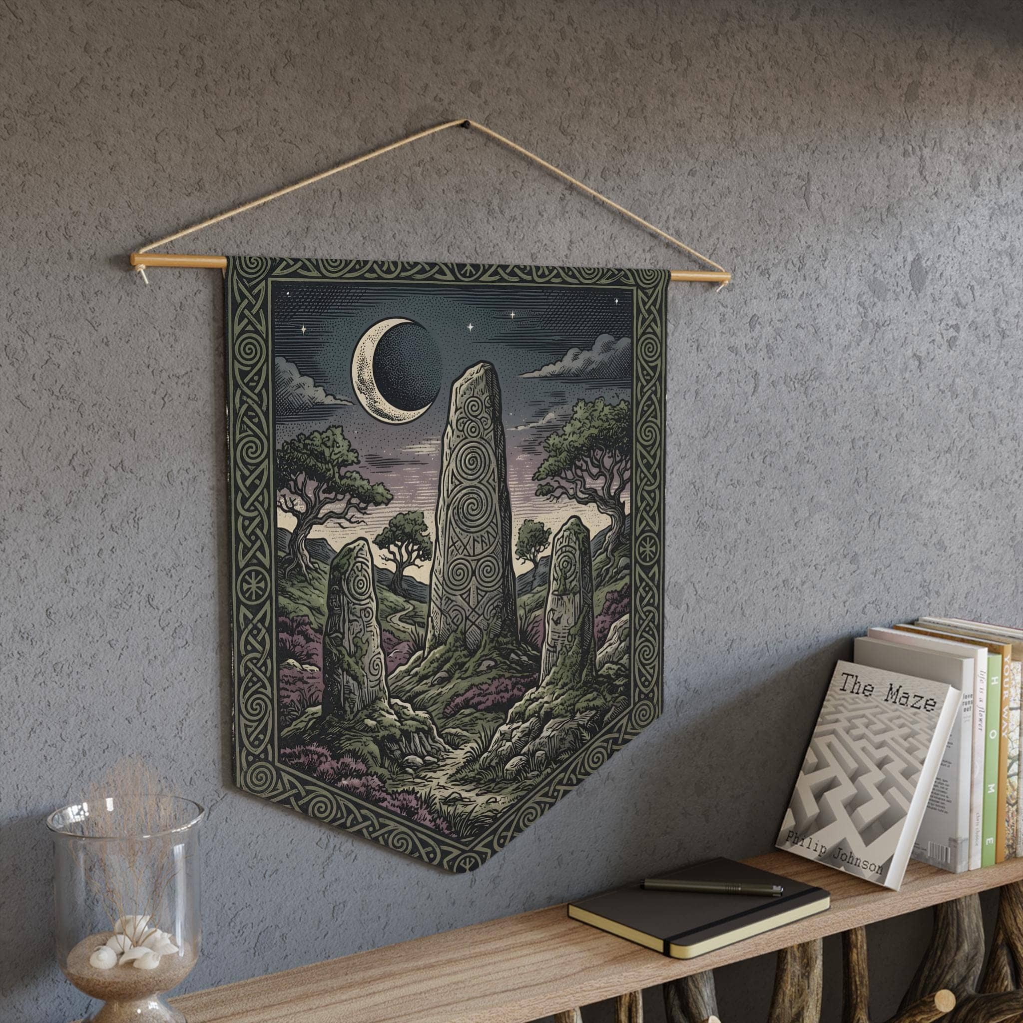 Vintage woodcut-style felt wall banner featuring an ancient runic monolith henge under a crescent moon, in a room setting
