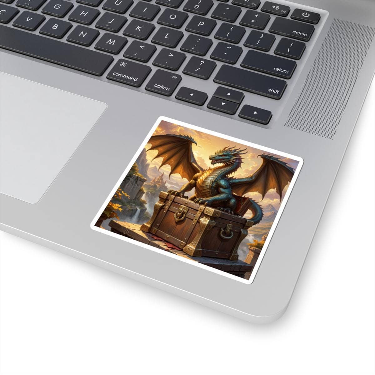 Epic fantasy sticker features a dragon perched atop a treasure chest, overlooking a castle and mountainous landscape with a waterfall